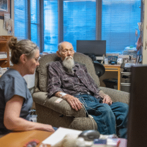 An old man and nurse are watching a tv.