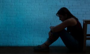 woman in the darkness in need of on demand mental health services