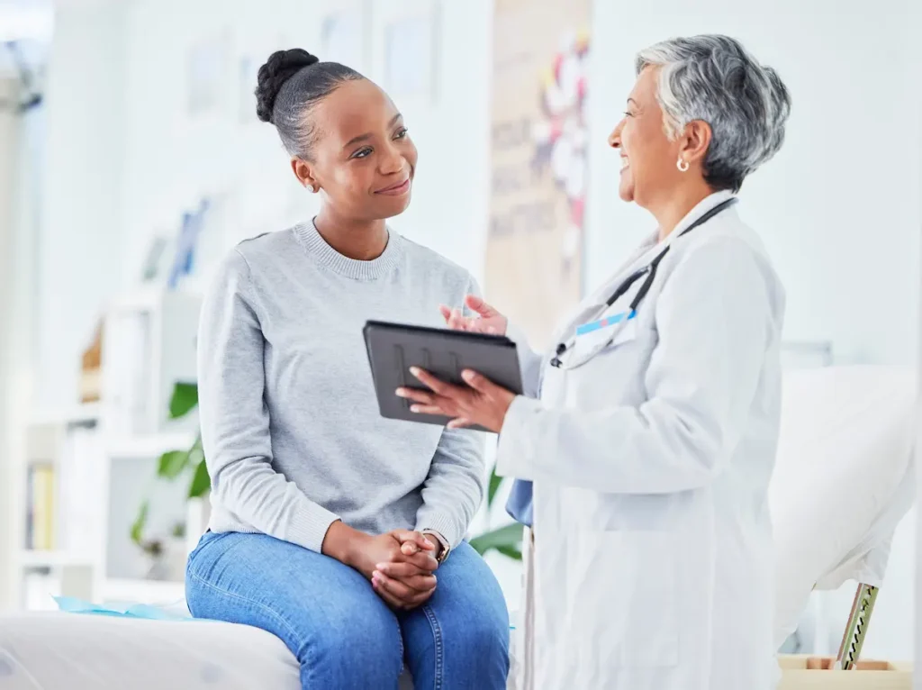 Doctor with patient utilizing telepsychiatry at the FQHC