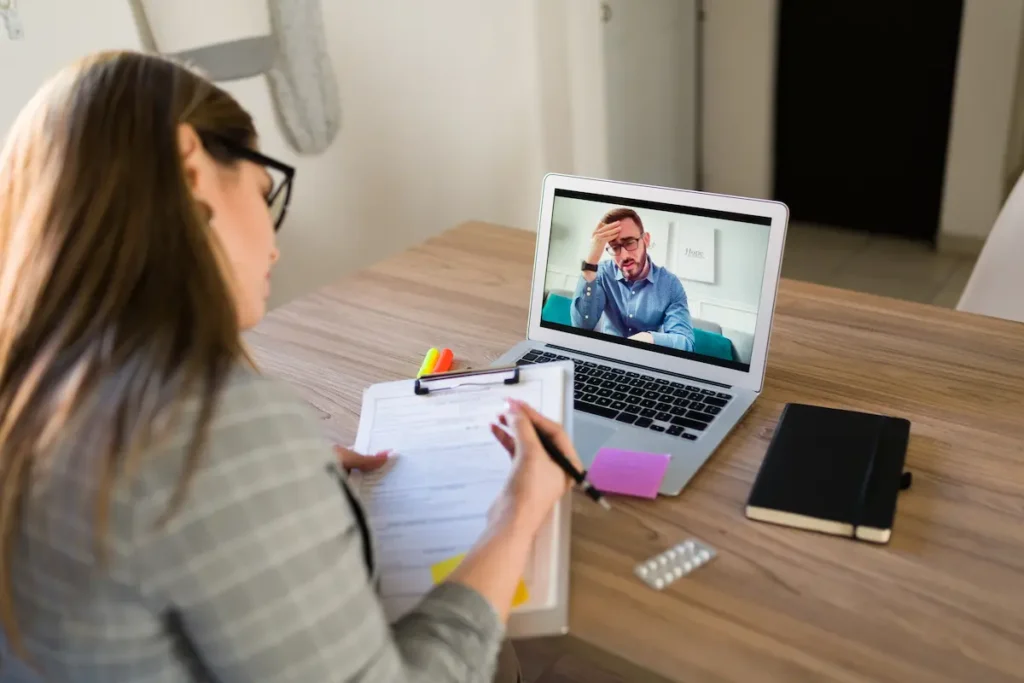 Therapy patient receiving telepsychiatry support at their counseling office