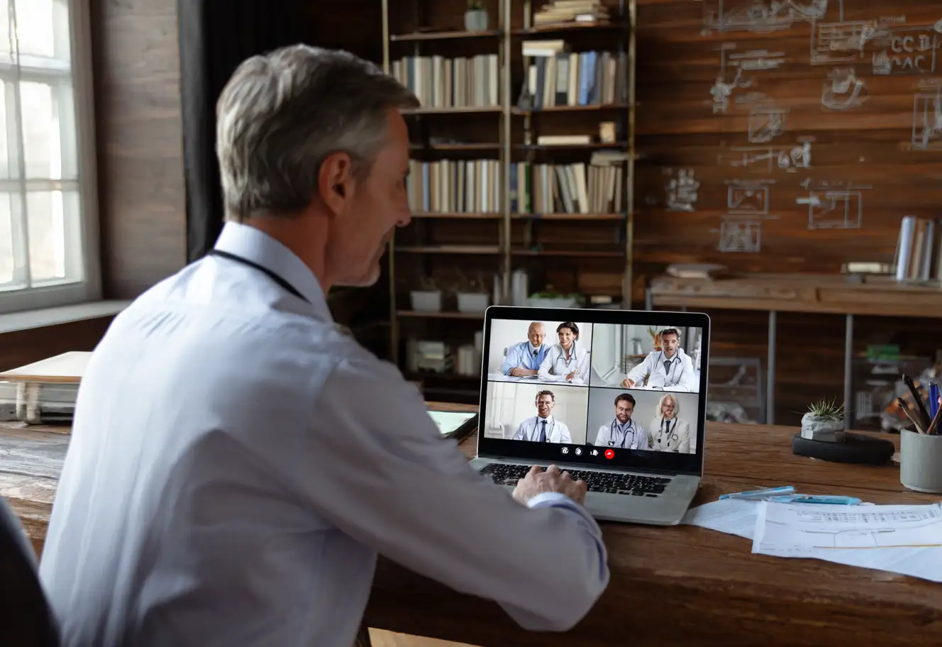 Doctor on a video call with 4 medical staff.