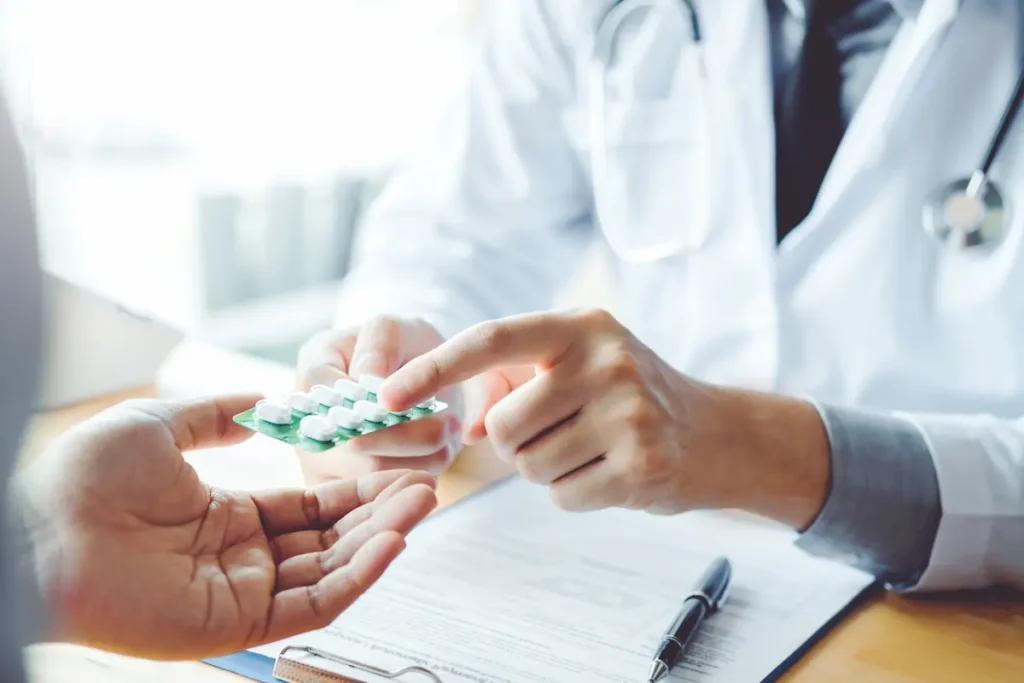 A doctor handing over medication.